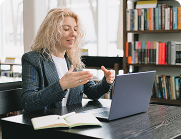 Businesswoman using a laptop and explaining with Signs